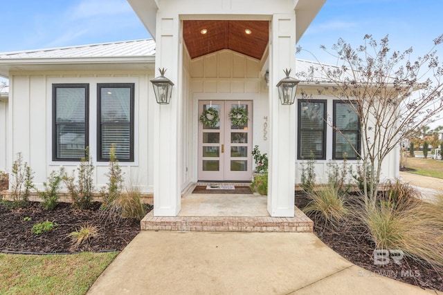 doorway to property with a standing seam roof, metal roof, french doors, and board and batten siding