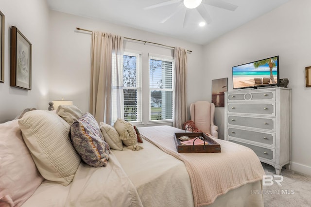 bedroom with light carpet, baseboards, and a ceiling fan