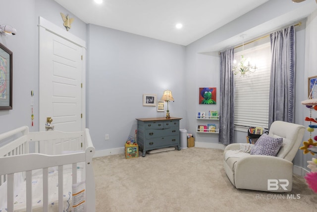 bedroom with carpet floors, a notable chandelier, recessed lighting, a nursery area, and baseboards