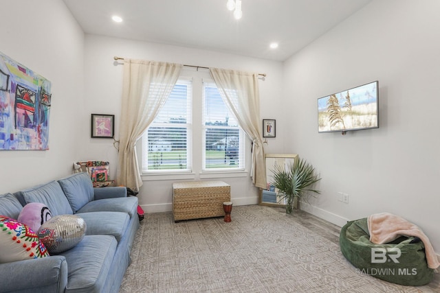 living area featuring recessed lighting and baseboards