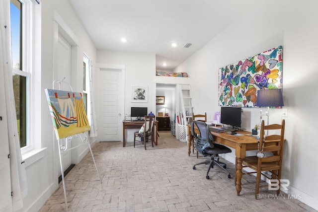 office featuring brick floor, recessed lighting, visible vents, and baseboards