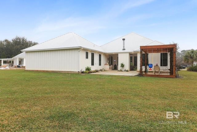 back of house featuring metal roof, a lawn, and a wooden deck