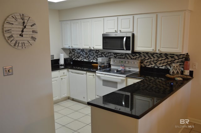 kitchen featuring white cabinetry, white range with electric stovetop, and stainless steel microwave