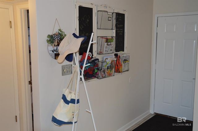 interior space with tile patterned flooring and baseboards