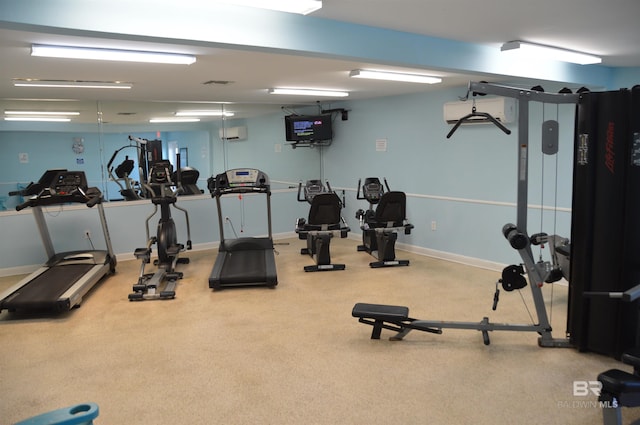 gym featuring an AC wall unit and baseboards