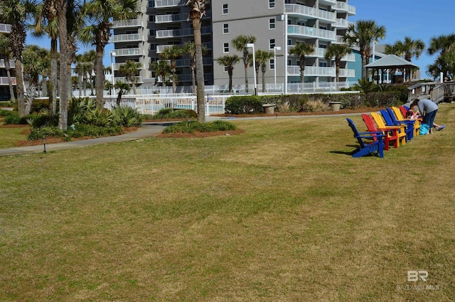 view of property's community with a lawn