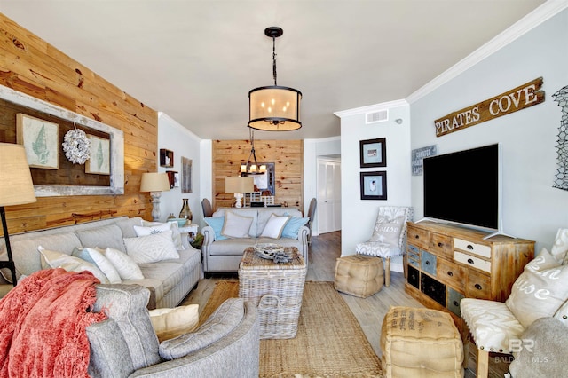 24900 Perdido Beach Blvd Unit 402, Orange Beach, AL 36561 - living room with visible vents, crown molding, wood finished floors, a notable chandelier, and wooden walls
