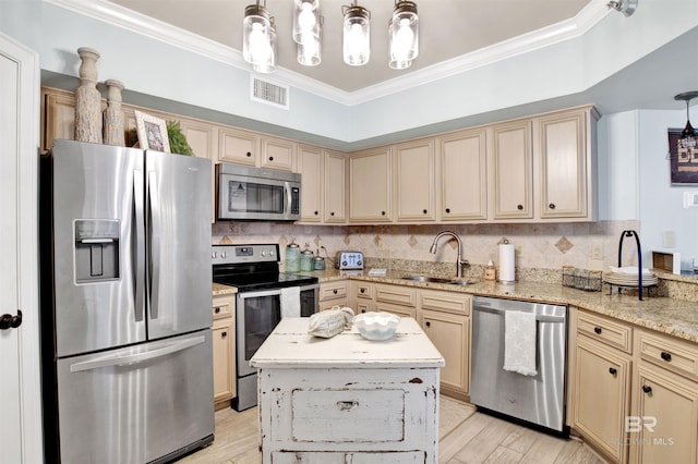 24900 Perdido Beach Blvd Unit 402, Orange Beach, AL 36561 - kitchen featuring visible vents, ornamental molding, cream cabinetry, a sink, and stainless steel appliances