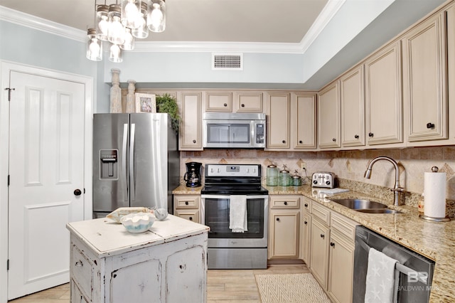 24900 Perdido Beach Blvd Unit 402, Orange Beach, AL 36561 - kitchen featuring cream cabinets, appliances with stainless steel finishes, a sink, tasteful backsplash, and ornamental molding
