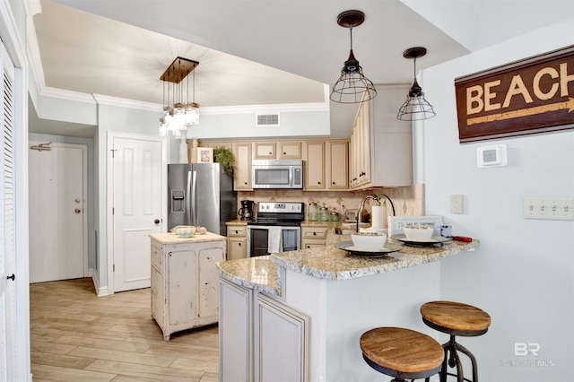 24900 Perdido Beach Blvd Unit 402, Orange Beach, AL 36561 - kitchen featuring visible vents, appliances with stainless steel finishes, tasteful backsplash, a peninsula, and ornamental molding