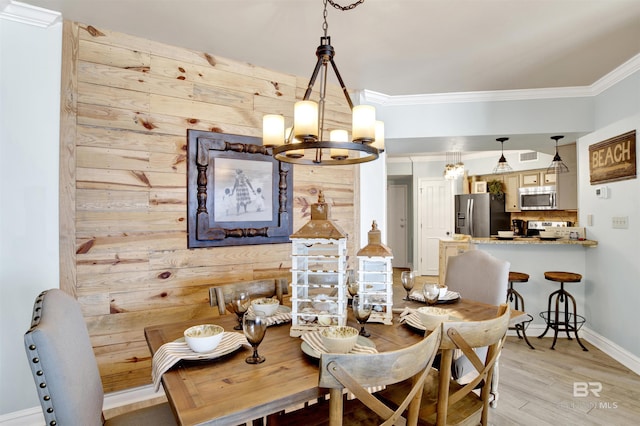 24900 Perdido Beach Blvd Unit 402, Orange Beach, AL 36561 - dining space with crown molding, baseboards, wooden walls, light wood-style flooring, and a notable chandelier