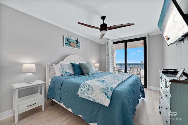 bedroom with access to exterior, ceiling fan, expansive windows, crown molding, and light hardwood / wood-style floors