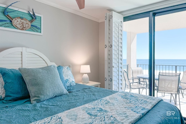 bedroom with a water view, ornamental molding, and multiple windows