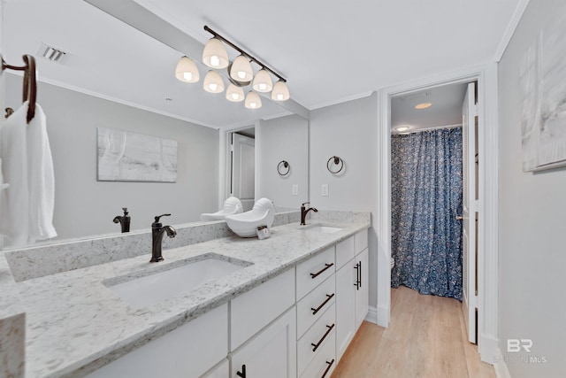 bathroom with hardwood / wood-style floors, vanity, a shower with curtain, and crown molding