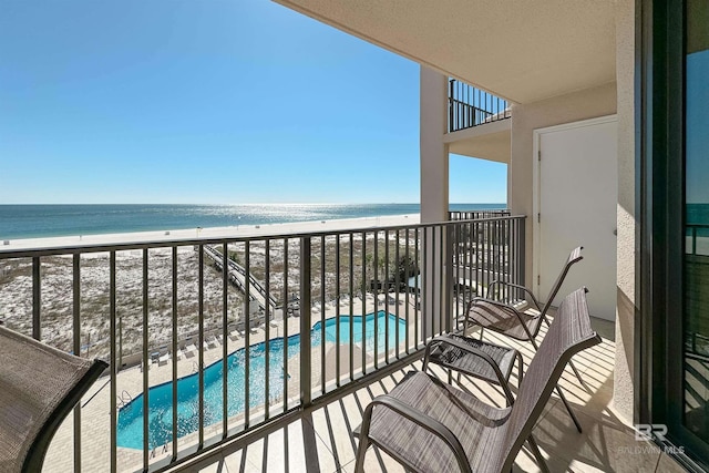 balcony with a view of the beach and a water view