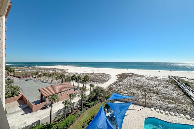 birds eye view of property with a view of the beach and a water view