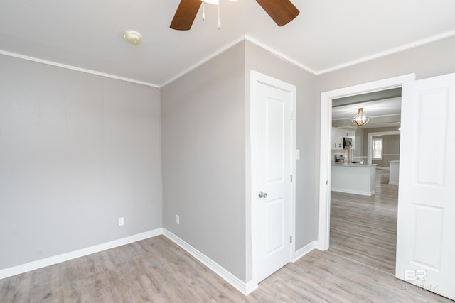 interior space with ceiling fan, light hardwood / wood-style floors, and ornamental molding