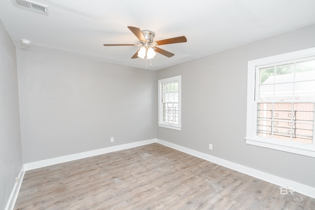 unfurnished room with ceiling fan and light hardwood / wood-style floors