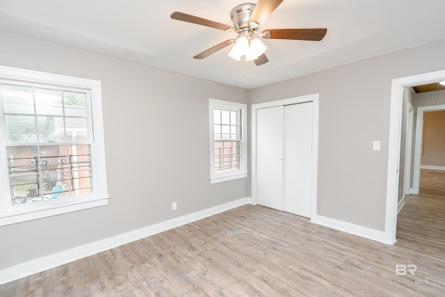 unfurnished bedroom with ceiling fan, light hardwood / wood-style floors, and a closet