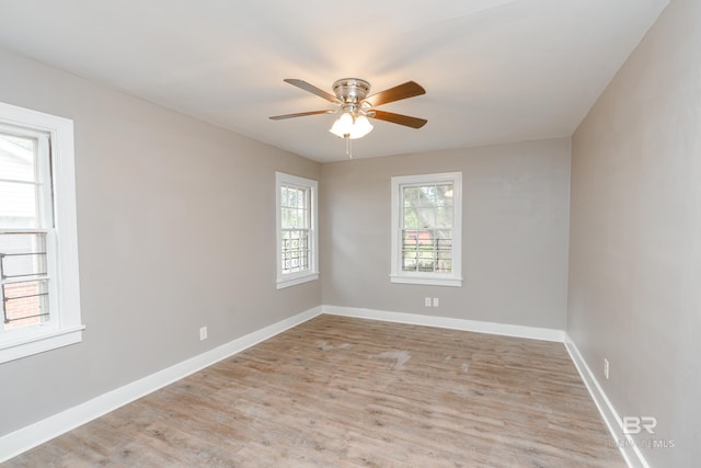 empty room with ceiling fan and light wood-type flooring