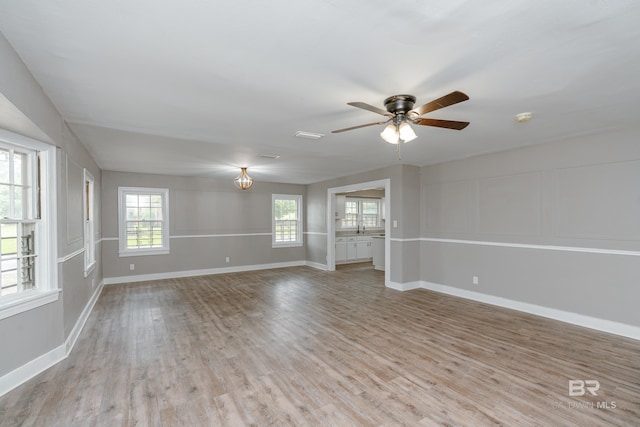 spare room with ceiling fan, sink, and light hardwood / wood-style floors