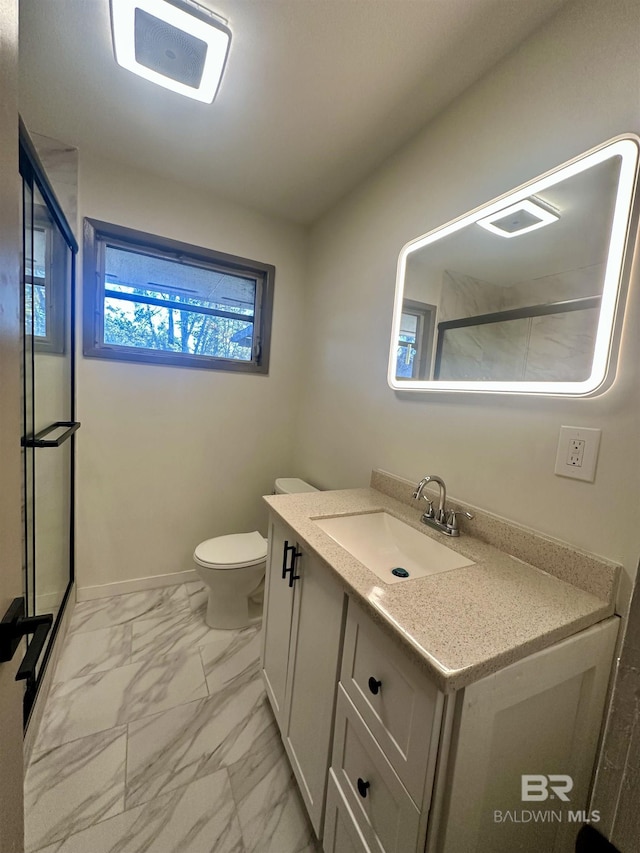 110 Lynnbrook Dr, Brewton, AL 36426 - bathroom featuring vanity, a shower with shower door, and toilet