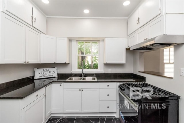 kitchen with white cabinets, dark stone countertops, black gas stove, and sink