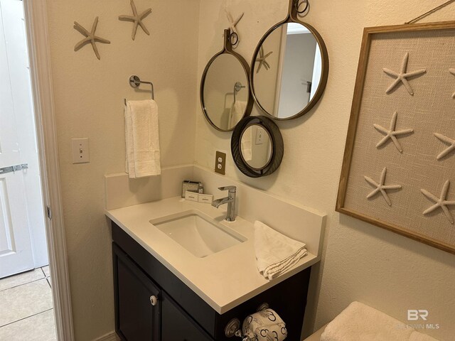 bathroom featuring tile floors and vanity