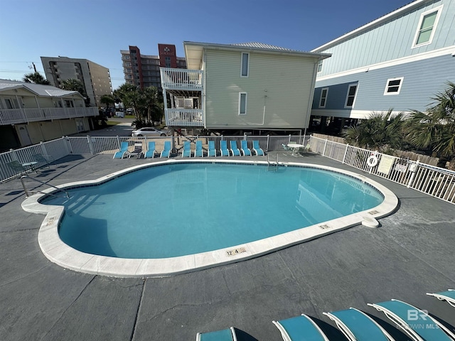 pool featuring a patio area and fence