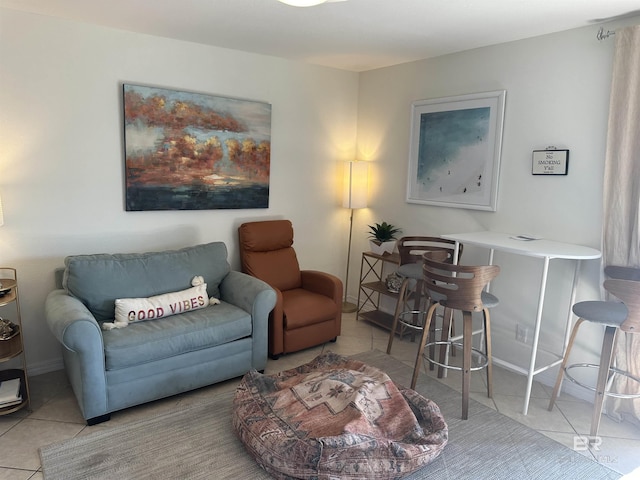 sitting room featuring light tile patterned flooring and baseboards