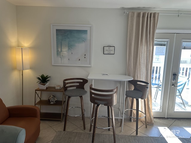 dining room featuring plenty of natural light, french doors, and light tile patterned flooring