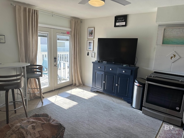 living room featuring ceiling fan, french doors, and light tile patterned flooring