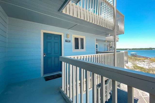 property entrance featuring a water view and a balcony