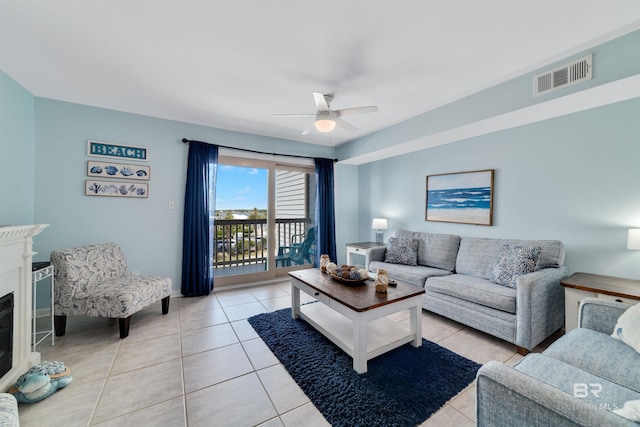 tiled living room with ceiling fan