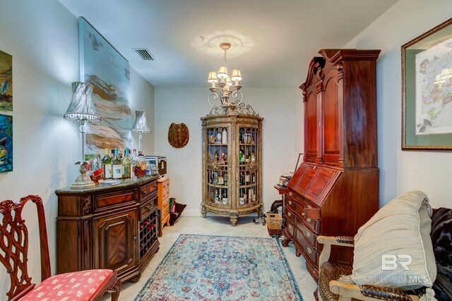 living area with an inviting chandelier and light tile patterned floors