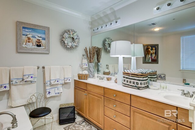 bathroom featuring tile patterned flooring, crown molding, and vanity