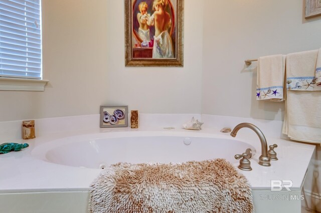 bathroom with a tub to relax in