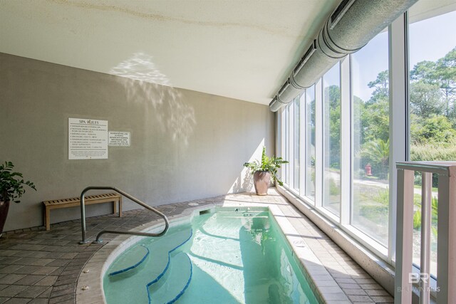 view of swimming pool with an indoor hot tub