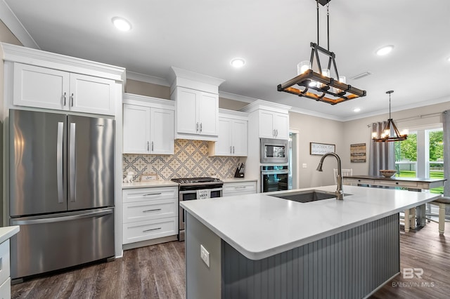 kitchen with sink, pendant lighting, a center island with sink, white cabinets, and appliances with stainless steel finishes