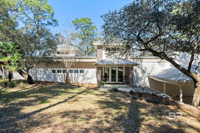 view of front of home featuring french doors and a front yard