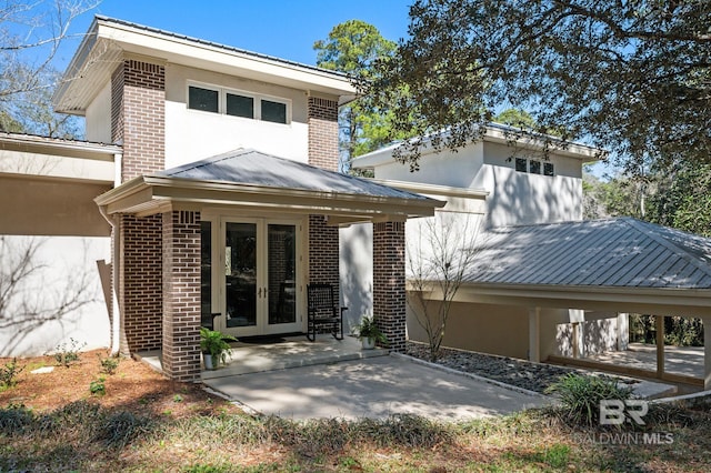 rear view of house featuring french doors