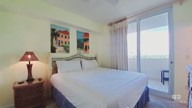 bedroom with tile flooring, ceiling fan, and access to outside