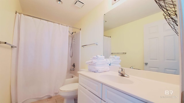 full bathroom with large vanity, toilet, tile floors, and shower / bath combo