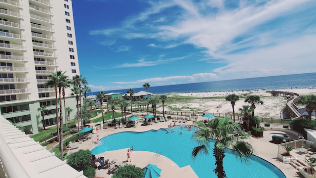 view of pool featuring a view of the beach and a water view