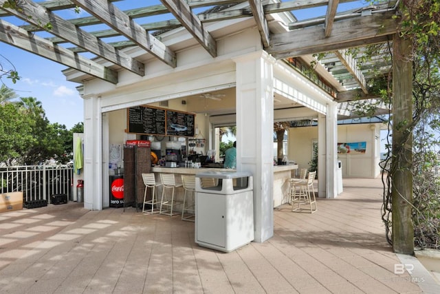 view of terrace with a pergola and an outdoor bar