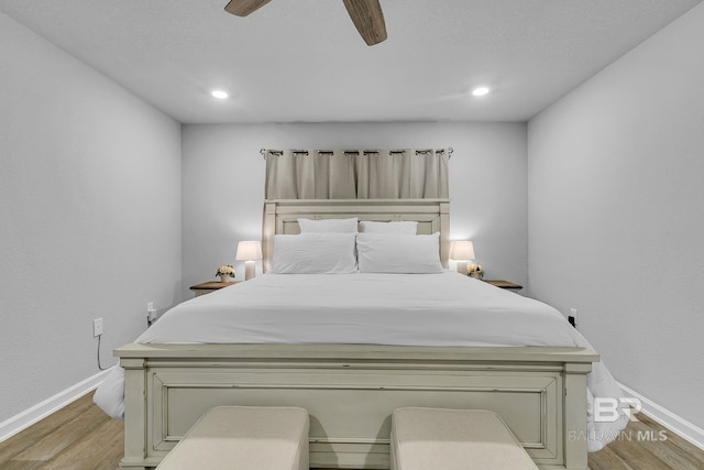 bedroom featuring light hardwood / wood-style flooring and ceiling fan