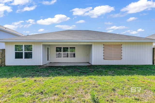 rear view of property with a lawn and a patio