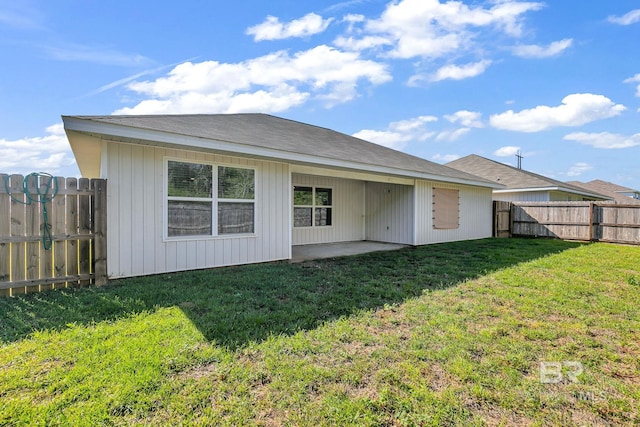 back of property featuring a yard