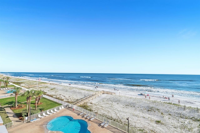 view of water feature with fence and a view of the beach