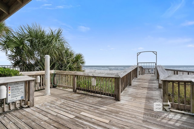 wooden terrace with a water view and a beach view